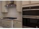 Modern kitchen features stainless steel appliances, light countertops, and a contemporary range hood at 482 Traditions Grande Blvd # 30, Wake Forest, NC 27587