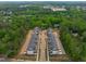 Aerial view of new townhouse construction in wooded area, showcasing modern community planning and design at 6420 Tanner Oak Ln, Raleigh, NC 27613