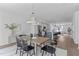 Open-concept dining room features a wood table, modern lighting, and seamless access to the kitchen at 6420 Tanner Oak Ln, Raleigh, NC 27613