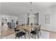 Open-concept dining room features a wood table, modern lighting, and seamless access to the kitchen at 6420 Tanner Oak Ln, Raleigh, NC 27613