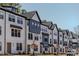 A row of townhouses with a modern farmhouse design featuring clean lines, contrasting colors and large windows at 6420 Tanner Oak Ln, Raleigh, NC 27613