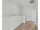 Bright hallway with hardwood floors and a white railing at 6420 Tanner Oak Ln, Raleigh, NC 27613