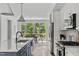Modern kitchen with a view into the dining area with stainless steel appliances and stylish cabinetry at 6420 Tanner Oak Ln, Raleigh, NC 27613