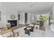 Spacious living room offering an open floor plan to kitchen and stairway, with fireplace and modern decor at 6420 Tanner Oak Ln, Raleigh, NC 27613