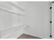 Walk-in pantry features floating shelves and countertops for optimal storage and organization at 6420 Tanner Oak Ln, Raleigh, NC 27613