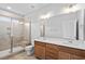 Bright bathroom with a glass enclosed shower, tile surround, and double sink vanity at 703 Jamescroft Way, Rolesville, NC 27587