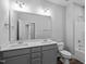 Elegant bathroom featuring double sinks, modern fixtures, and neutral gray accents at 703 Jamescroft Way, Rolesville, NC 27587
