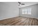 Bedroom featuring neutral walls, wood-look flooring, and large window providing ample natural light at 703 Jamescroft Way, Rolesville, NC 27587