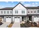 Inviting townhouse featuring a manicured lawn, a smooth driveway, and an attached one car garage at 703 Jamescroft Way, Rolesville, NC 27587