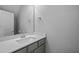 Stylish half bathroom with a modern vanity and mirror at 703 Jamescroft Way, Rolesville, NC 27587