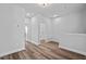 Open hallway featuring hardwood flooring, neutral paint, and ample lighting at 703 Jamescroft Way, Rolesville, NC 27587
