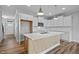 Bright and open kitchen with white cabinets, island with light wood accent, and stainless appliances at 703 Jamescroft Way, Rolesville, NC 27587