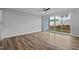 Living room with wood-look flooring, ceiling fan, and sliding glass doors to the backyard at 703 Jamescroft Way, Rolesville, NC 27587