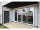 Relaxing patio area with sliding glass doors, a dark door, and concrete, providing a seamless transition to the outdoors at 703 Jamescroft Way, Rolesville, NC 27587
