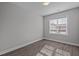 A cozy bedroom with neutral walls and a large window, modern flooring at 707 Jamescroft Way, Rolesville, NC 27587