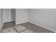 A simple bedroom with neutral walls, modern flooring, and a white door at 707 Jamescroft Way, Rolesville, NC 27587