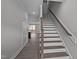 Inviting entryway showcases a staircase with wooden handrail and modern flooring leading to an open living space at 707 Jamescroft Way, Rolesville, NC 27587