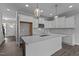 Bright kitchen featuring white cabinets, stainless steel appliances, and a central island with pendant lighting at 707 Jamescroft Way, Rolesville, NC 27587