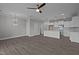 Living room view with hardwood floors seamlessly connecting to an open kitchen and dining area at 707 Jamescroft Way, Rolesville, NC 27587