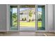 View of the backyard with a small grass area, privacy fence, and adjacent brick building at 709 Jamescroft Way, Rolesville, NC 27587