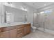 Modern bathroom features double sinks and a glass-enclosed tile shower at 709 Jamescroft Way, Rolesville, NC 27587