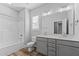 Bathroom features a shower-tub combo, double sink vanity with gray cabinets, and a large mirror at 709 Jamescroft Way, Rolesville, NC 27587