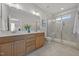 Modern bathroom with double vanity, tiled flooring, and frameless glass shower with tiled walls at 709 Jamescroft Way, Rolesville, NC 27587
