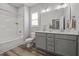 Bathroom with a double vanity, a shower-tub combo, and modern fixtures at 709 Jamescroft Way, Rolesville, NC 27587