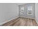 Bright bedroom featuring wood-look floors and a double window allowing natural light at 709 Jamescroft Way, Rolesville, NC 27587