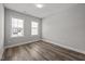Well-lit bedroom with wood-look flooring and large windows at 709 Jamescroft Way, Rolesville, NC 27587