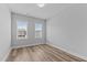 Bright bedroom with wood flooring and two windows providing ample natural light at 709 Jamescroft Way, Rolesville, NC 27587