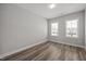 This bedroom offers natural light from two windows and features hardwood flooring at 709 Jamescroft Way, Rolesville, NC 27587