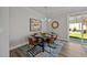 Modern dining room with stylish decor, a contemporary light fixture, and outdoor access at 709 Jamescroft Way, Rolesville, NC 27587