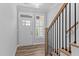 Bright entryway featuring wood-look flooring, natural wood stairs with black wrought iron spindles at 709 Jamescroft Way, Rolesville, NC 27587
