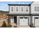 Charming two-story townhome with grey siding, white trim, and a one-car garage offers modern curb appeal at 709 Jamescroft Way, Rolesville, NC 27587