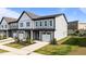 New two-story townhouse featuring a one car garage, gray siding, and manicured landscaping at 709 Jamescroft Way, Rolesville, NC 27587