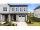 New two-story townhouse featuring a one car garage, gray siding, and manicured landscaping at 709 Jamescroft Way, Rolesville, NC 27587