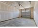 Spacious two car garage with gray doors and concrete flooring at 709 Jamescroft Way, Rolesville, NC 27587