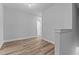 Hallway featuring modern wood-look flooring and neutral paint scheme at 709 Jamescroft Way, Rolesville, NC 27587