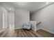 Open hallway with wood-look flooring and staircase, leading to an upstairs landing area at 709 Jamescroft Way, Rolesville, NC 27587