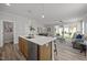 Open-concept kitchen and living area with island seating and abundant natural light at 709 Jamescroft Way, Rolesville, NC 27587