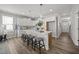 Bright, open kitchen with a large island, white cabinets, and modern pendant lighting at 709 Jamescroft Way, Rolesville, NC 27587