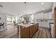 Spacious kitchen with island seating flows into a living area with sliding glass doors at 709 Jamescroft Way, Rolesville, NC 27587