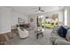 Bright living room features an open floor plan, stylish decor, and sliding glass doors to the backyard at 709 Jamescroft Way, Rolesville, NC 27587