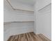 Spacious walk-in closet featuring ample hanging space and modern wood-look flooring at 709 Jamescroft Way, Rolesville, NC 27587
