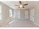 This is a light, bright carpeted bedroom with ceiling fan and two closets at 806 Roberts Rd, Sanford, NC 27332