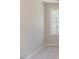 This is a carpeted bedroom with a window offering a view at 806 Roberts Rd, Sanford, NC 27332