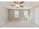 This is a bright carpeted bedroom with two windows that let in plenty of natural light at 806 Roberts Rd, Sanford, NC 27332
