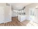 Bright kitchen featuring white cabinets, sleek countertops, and wood-look floors, adjacent to the entry door at 806 Roberts Rd, Sanford, NC 27332