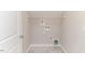Bright laundry room with tile floors, shelving, and modern hookups at 806 Roberts Rd, Sanford, NC 27332